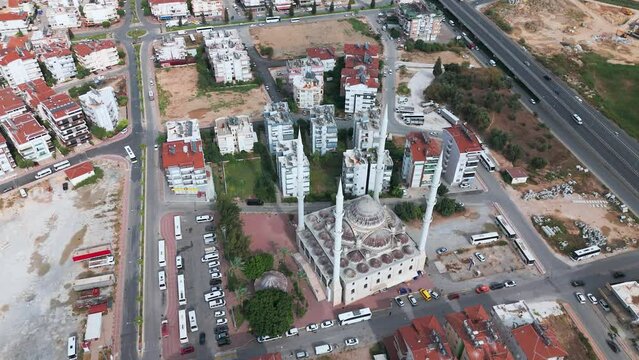 Aerial view looking down above Manavgat mosque minaret towers and historic Turkish old town rooftops