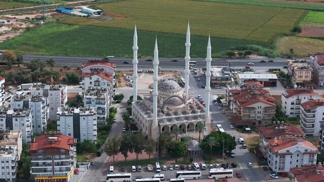 Aerial view circling the Manavgat mosque in the Antalya region with fields in the background, Turkey