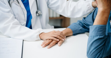 The doctor holds the patient’s. hand Healthcare and medical concept. In hospital.