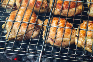 Chicken meat grilling on the brazier. Selective focus.