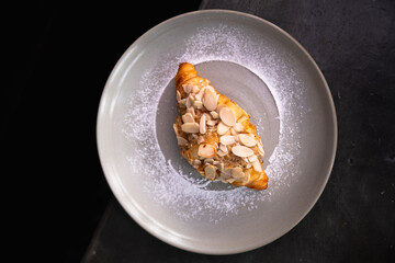 almond croissant with powdered sugar
