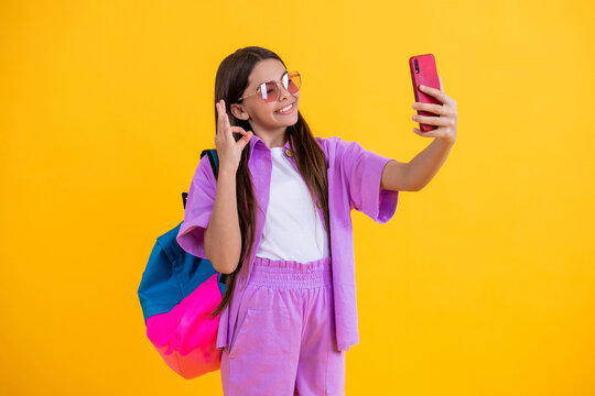 teen girl make selfie at school. school blog. online audience. selfie time for school girl. teen blogger with phone. girl making selfie. peace