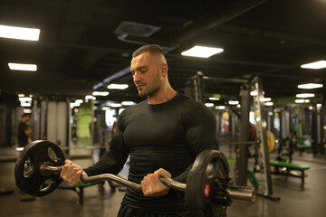 Muscular man during workout in the gym. 