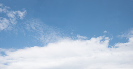 blue sky background with copy space and white band of clouds below
