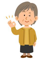 OKサインを出す黄色いカーディガンを着たシニアの女性　全身
