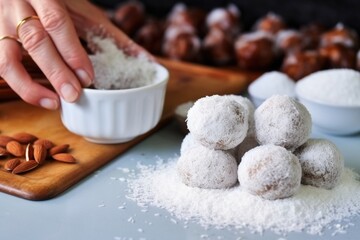 Fototapeta na wymiar coating date and nut balls in desiccated coconut