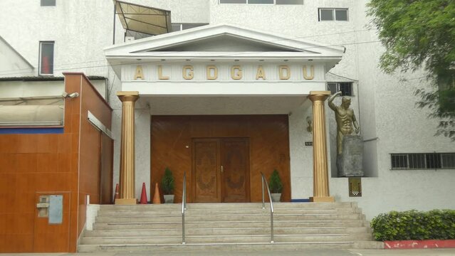 A Masonic temple or lodge. Two golden pillars on each side. On the top the acronym of ALGDGADU which is abbreviation in Spanish for Glory to the grand architect of the universe. Located in Lima, Peru.