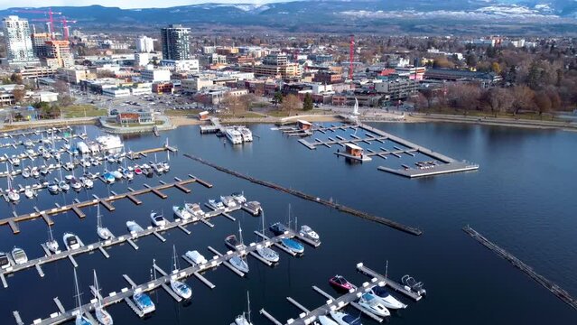 Beautiful Waterfront Yacht Club and Marina in Beautiful Canadian City. Downtown Kelowna Waterfront on a Sunny Spring. Kelowna Marina Dock and Sail Statue.