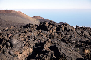 Mount Etna, Sicily, Italy. Slopes of volcano are covered with volcanic ash and frozen lava. Summer mountain landscape on sunny day