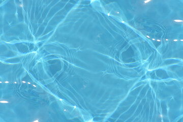 Defocus blurred transparent blue colored clear calm water surface texture with splashes reflection. Trendy abstract nature background. Water waves in sunlight with copy space. Blue watercolor shine.