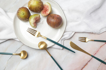 Creative shot of golden cutlery on marble table, Design concept. Modern kitchen. Scandinavian style tableware.