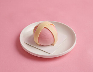 pink sweet dessert with white chocolate stripe on pink background