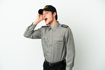 Young Russian security man isolated on white background doing surprise gesture while looking to the side