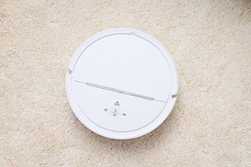 White cordless vacuum cleaner on carpet, top view