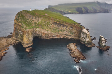 Mykines lighthouse and cliffs on Faroe islands from helicopter