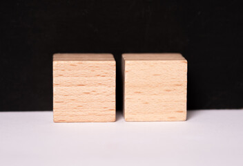 Two empty wooden cubes with place for letters