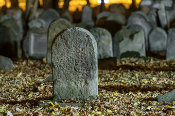 Tombstones in an old cemetery at night. - 656932541