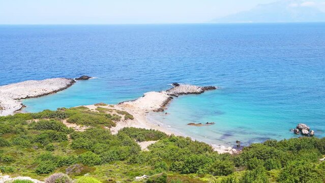 Saint George beach with view from Drakano tower fortress watchtower archeological site on Ikarian Sea, Greek Aegean islands of Ikaria island, Greece