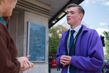 Young business colleagues discussing in front of building