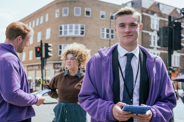 Young businessman standing with colleagues in background