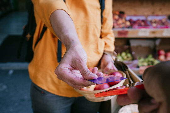 Woman making contactless payment at supermarket