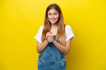 Young caucasian woman isolated on yellow background laughing