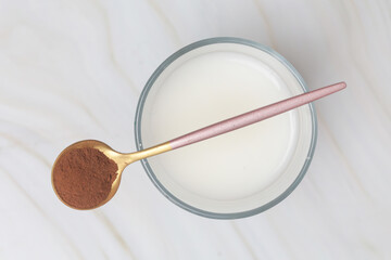 Unsweetened dark chocolate cacao powder in the spoon
