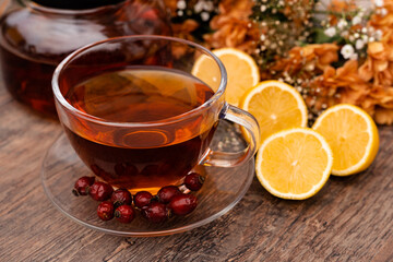 Rosehip tea with lemon in a clear cup. Autumn drink for colds