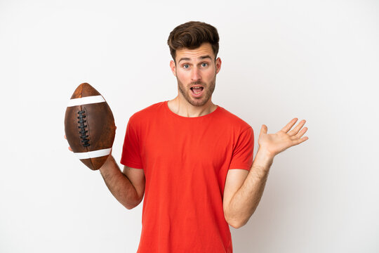 Young caucasian man playing rugby isolated on white background with shocked facial expression