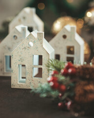 House shaped candle holder. Christmas cozy interior decor. Decorative Christmas-themed figurines. Selective focus