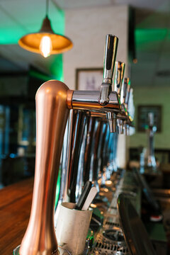 Shiny brewery taps in row at pub