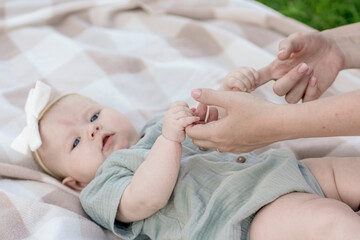 Obraz na płótnie Canvas Closeup newborn baby's hand holding a mother's finger.