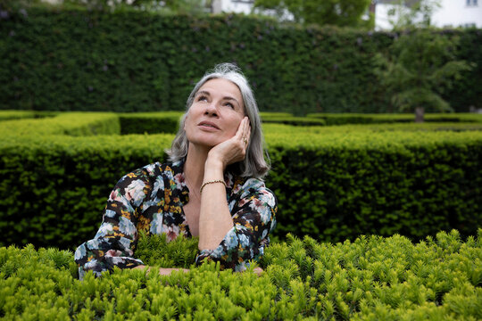 Contemplative woman spending leisure time in park