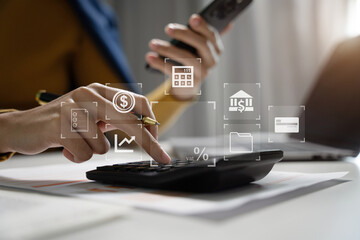 Businesswoman working with smartphone and using a calculator to calculate the numbers of static in...