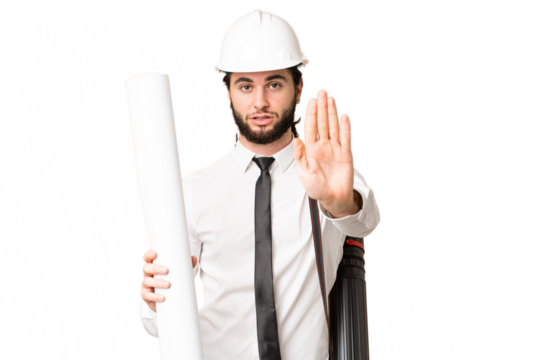 Young architect man with helmet and holding blueprints over isolated chroma key background making stop gesture - Powered by Adobe