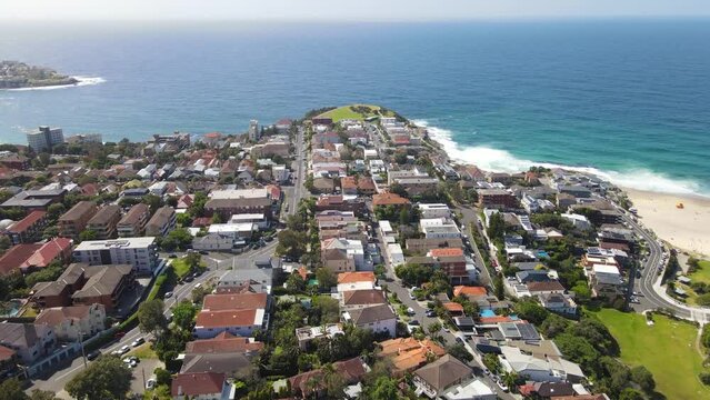 Aerial drone view of homes and streets above the beachside suburb of Tamarama, looking toward Tamarama Beach in east Sydney, NSW Australia on a sunny morning