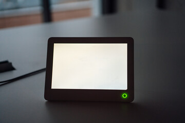 Tablet PC with white blank screen at desk