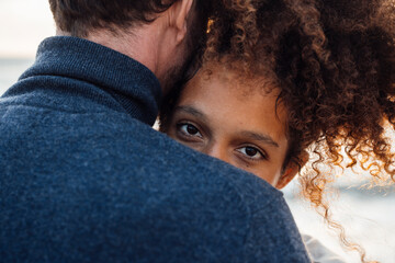 Woman with curly hair embracing boyfriend