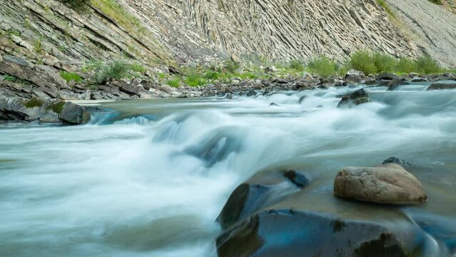Time lapse video of fast mountain river flowing on rocks. River Prut making its way through rocks and stones in Carpathian mountains