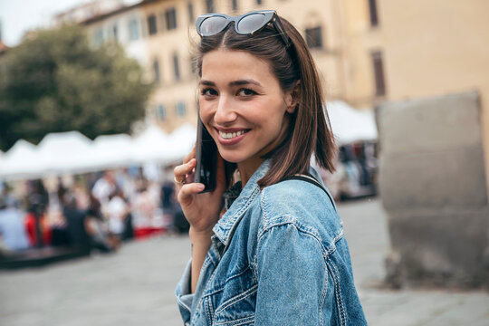 Smiling woman talking on smart phone