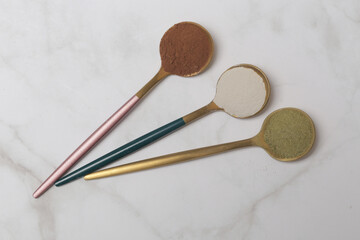 Different types of dietary supplements for health and beauty - collagen, vitamins, biotin, protein powder in spoons
