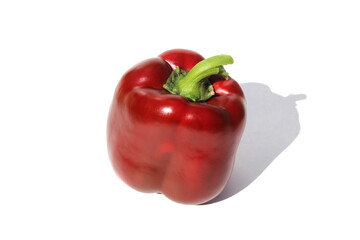 Red pepper lies on a white isolated background.