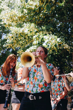 Woman playing trumpet with folk group