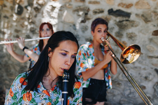 Woman practicing clarinet with folk music group