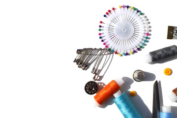 Sewing supplies lie on a white isolated background.