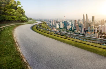 Poster Im Rahmen Road with cityscape and skyline in Kuala Lumpur, Malaysia. Sunrise Scene. Logo removed. © LAYHONG