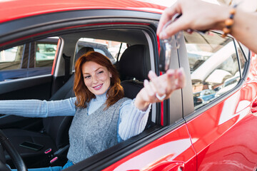 Smiling woman taking car keys from man