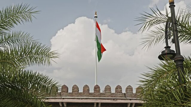 indian flag swaying in a building and clouds in the background daytime 4k 25p