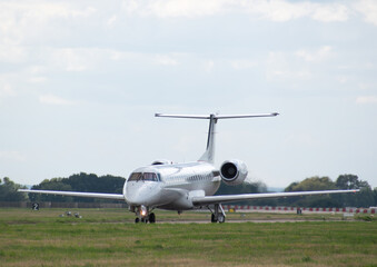 Fototapeta na wymiar military raf Embraer airplane setting off taxiing on runway 