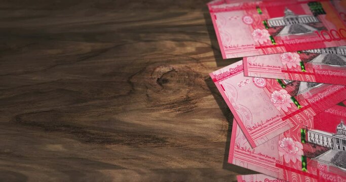 Dominican Peso 1000 DOP banknotes on the wooden table. Dominican currency paper notes 3D concept background. Seamless and looped.
